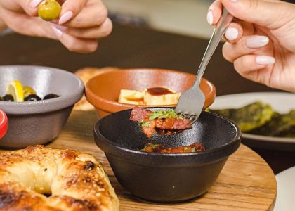 A delightful Middle Eastern breakfast spread featuring olives, bread, and various small dishes, showcasing vibrant flavors.